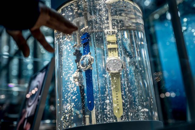 This photograph shows "Luminor Marina" waterproof model watches displayed in an aquarium at the booth of Italian luxury watch manufacturer Panerai, owned by Richemont group, during the opening day of the "Watches and Wonders Geneva" luxury watch fair, in Geneva on April 14, 2026. The Geneva watch fair opened on April 14 and will be taken as a barometer of how the Middle East war is affecting the luxury goods sector. The Watches and Wonders salon -- the industry's biggest annual event -- sees 65 major watch brands, including Rolex, Patek Philippe, Cartier and Bulgari, display their latest creations until April 20. (Photo by Fabrice COFFRINI / AFP)
