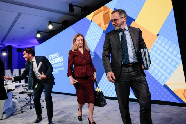 Pierre-Olivier Gourinchas (R), Director of IMF Research Department, and Petya Koeva Brooks (C), Deputy Director of IMF Research Department, depart after speaking at an economic outlook briefing during the 2026 IMF and World Bank Group Spring Meetings in Washington, DC, on April 14, 2026. (Photo by Kent NISHIMURA / AFP)
