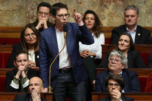 La France Insoumise - Nouveau Front Populaire's MP Hadrien Clouet (standing) delivers a speech during a session of questions to the government at the National Assembly, France's lower house of parliament, in Paris on April 14, 2026. (Photo by Alain JOCARD / AFP)