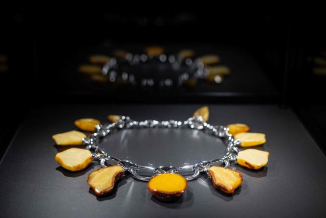 This picture taken at the exhibion of Amber Museum in Gdansk presents piece of artistic jewellery made of natural Baltic amber, designed and created at workshops of Experimental Design Stuio of Academy of Fine Arts in Gdansk, Poland on March 10, 2026. Long coveted for its golden color, scientific value and alleged healing properties, amber is now coming into the hand of young Polish jewelers, bringing the ancient resin into modern times. Together with drills, sanders, blasters, and power saws which look like they belong to a bygone era, virtual reality stations are used to combine earlier tools with state-of-the-art technology at the Academy of Fine Arts in Gdansk, a city on Poland's Baltic Coast known as amber's global capital. (Photo by Wojtek RADWANSKI / AFP)