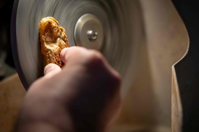An amber craftsman polishes a piece of Baltic amber to turn it into jewellery at the studio of designer Mariusz Gliwinski, “Ambermoda”, in Sopot on March 27, 2026. Gliwinski’s company is one of 200 exhibitors at this year’s Amberif, a fair held annually in Gdansk where entrepreneurs, craftsmen and artists from all over the world who work with amber can sell or buy amber, establish new contracts or simply showcase their offerings. (Photo by Wojtek RADWANSKI / AFP)