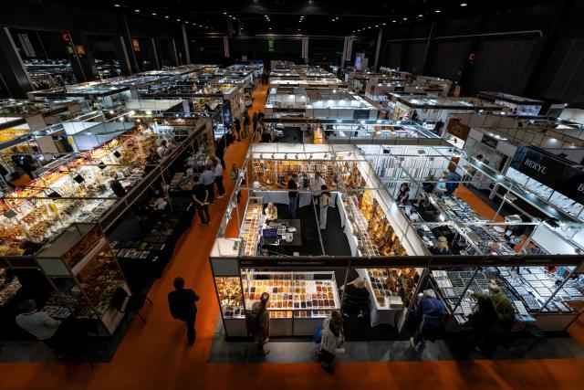 Visitors walk between stalls at the Amberif Fair in Gdansk on March 26, 2026. Around 200 exhibitors take part in this year’s Amberif, a fair held annually in Gdansk where entrepreneurs, craftsmen and artists from all over the world who work with amber can sell or buy amber, establish new contracts or simply showcase their offerings. (Photo by Wojtek RADWANSKI / AFP)