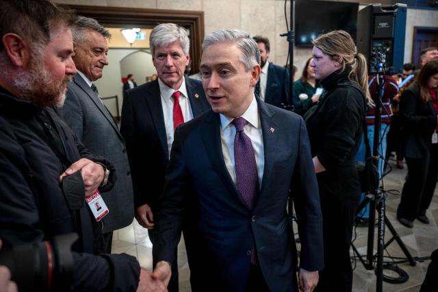 Canadian Finance Minister Francois-Philippe Champagne arrives for a press conference held by Canadian Prime Minister Mark Carney at the West Block on Parliament Hill in Ottawa, Ontario, Canada, on April 14, 2026. Carney's Liberal party secured a majority in Canada's parliament on April 13 after winning all three by-election seats up for grabs, boosting his Liberals as they work to bolster a country shaken by threats from the United States. (Photo by ANDREJ IVANOV / AFP)
