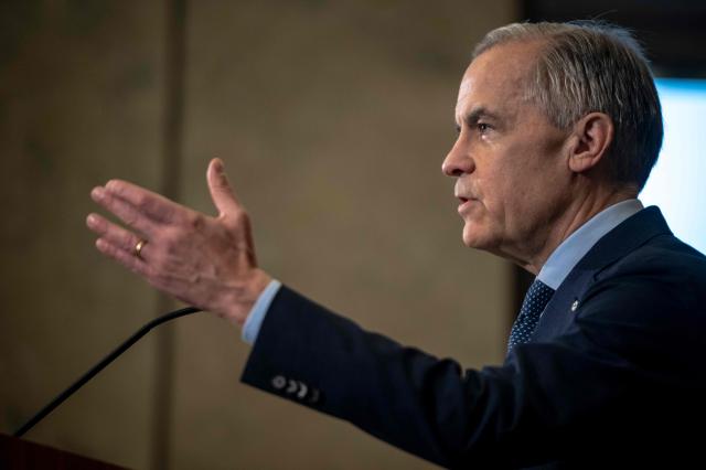 Canadian Prime Minister Mark Carney speaks during a press conference at the West Block on Parliament Hill in Ottawa, Ontario, Canada, on April 14, 2026. Carney's Liberal party secured a majority in Canada's parliament on April 13 after winning all three by-election seats up for grabs, boosting his Liberals as they work to bolster a country shaken by threats from the United States. (Photo by ANDREJ IVANOV / AFP)