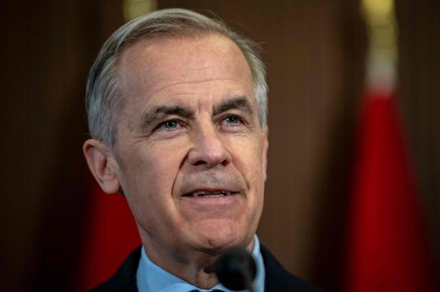 Canadian Prime Minister Mark Carney speaks during a press conference at the West Block on Parliament Hill in Ottawa, Ontario, Canada, on April 14, 2026. Carney's Liberal party secured a majority in Canada's parliament on April 13 after winning all three by-election seats up for grabs, boosting his Liberals as they work to bolster a country shaken by threats from the United States. (Photo by ANDREJ IVANOV / AFP)