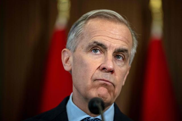 Canadian Prime Minister Mark Carney speaks during a press conference at the West Block on Parliament Hill in Ottawa, Ontario, Canada, on April 14, 2026. Carney's Liberal party secured a majority in Canada's parliament on April 13 after winning all three by-election seats up for grabs, boosting his Liberals as they work to bolster a country shaken by threats from the United States. (Photo by ANDREJ IVANOV / AFP)
