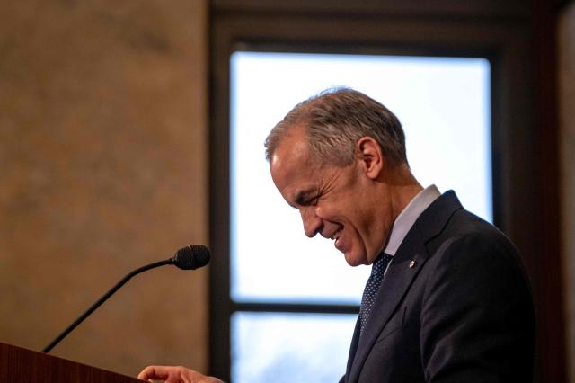 Canadian Prime Minister Mark Carney speaks during a press conference at the West Block on Parliament Hill in Ottawa, Ontario, Canada, on April 14, 2026. Carney's Liberal party secured a majority in Canada's parliament on April 13 after winning all three by-election seats up for grabs, boosting his Liberals as they work to bolster a country shaken by threats from the United States. (Photo by ANDREJ IVANOV / AFP)