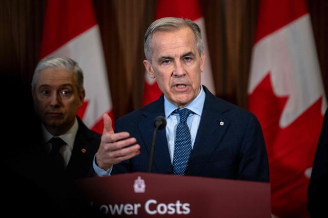 Canadian Prime Minister Mark Carney speaks during a press conference at the West Block on Parliament Hill in Ottawa, Ontario, Canada, on April 14, 2026. Carney's Liberal party secured a majority in Canada's parliament on April 13 after winning all three by-election seats up for grabs, boosting his Liberals as they work to bolster a country shaken by threats from the United States. (Photo by ANDREJ IVANOV / AFP)