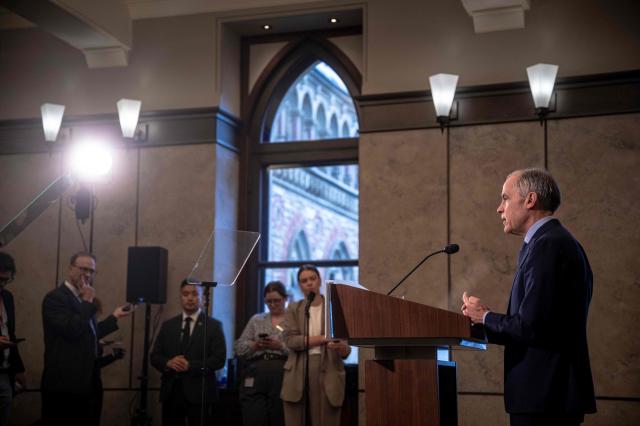 Canadian Prime Minister Mark Carney speaks during a press conference at the West Block on Parliament Hill in Ottawa, Ontario, Canada, on April 14, 2026. Carney's Liberal party secured a majority in Canada's parliament on April 13 after winning all three by-election seats up for grabs, boosting his Liberals as they work to bolster a country shaken by threats from the United States. (Photo by ANDREJ IVANOV / AFP)