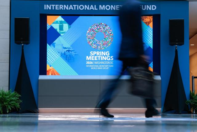 A man walks through the atrium during the 2026 IMF and World Bank Group Spring Meetings in Washington, DC, on April 14, 2026. (Photo by Kent NISHIMURA / AFP)