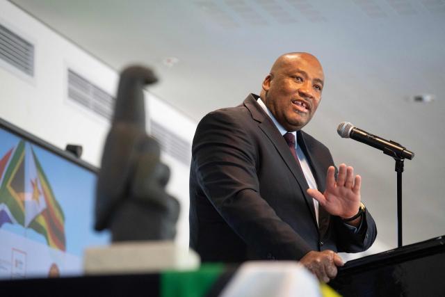 South African Minister of Sports, Arts and Culture, Gayton McKenzie speaks behind the Zimbabwean Bird, a soapstone sculpture of national significance, at a repatriation handover event at the Iziko South African Museum, in Cape Town, on April 14, 2026. South Africa on Tuesday handed back to Zimbabwe ancestral human remains and a centuries-old stone carving of its sacred national emblem, the Zimbabwe bird, taken more than 100 years ago during the colonial era.
The restitution was part of a worldwide push for artefacts looted from African countries during the colonial era to be repatriated. (Photo by RODGER BOSCH / AFP)