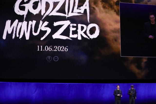 (L-R) Interpreter Michael McNamara and Japanese director Takashi Yamazaki present the movie "Godzilla Minus Zero" during "The State of the Industry" and NEON presentation at CinemaCon at The Colosseum at Caesars Palace in Las Vegas, Nevada, on April 14, 2026. (Photo by VALERIE MACON / AFP)