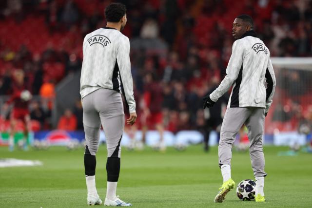 Paris Saint-Germain's Moroccan defender #02 Achraf Hakimi (L) and Paris Saint-Germain's French forward #10 Ousmane Dembele (R) warm up ahead of the UEFA Champions League quarter final, second-leg football match between Liverpool and Paris Saint-Germain at Anfield in Liverpool, north west England on April 14, 2026. (Photo by FRANCK FIFE / AFP)