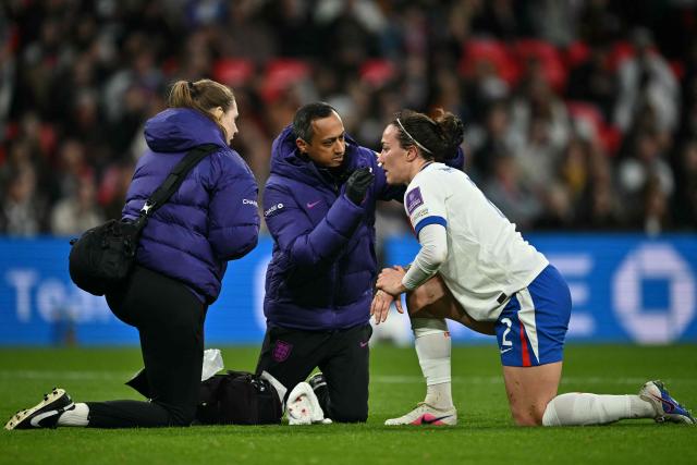 England's defender #02 Lucy Bronze receives medical treatment after suffering a knock during the Women's FIFA world cup league A, group 3, qualifier football match between England and Spain at Wembley stadium, in London on April 14, 2026. (Photo by Ben STANSALL / AFP)