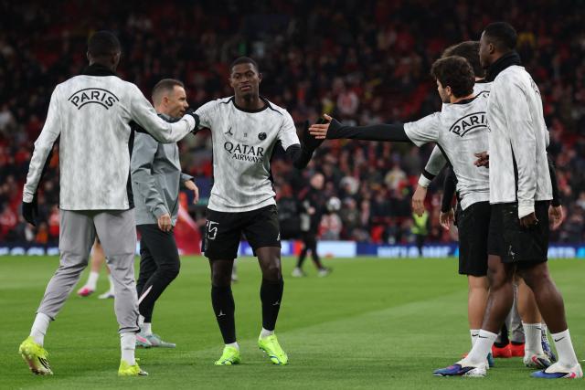 Paris Saint-Germain's Portuguese defender #25 Nuno Mendes (C) warms up with teammates during the UEFA Champions League quarter final, second-leg football match between Liverpool and Paris Saint-Germain at Anfield in Liverpool, north west England on April 14, 2026. (Photo by FRANCK FIFE / AFP)