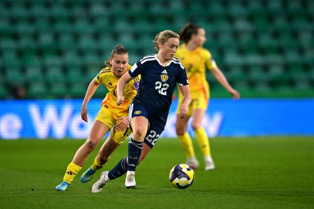 Scotland's Midfielder #22 Erin Cuthbert runs with the ball from Belgium's midfielder #10 Jarne Teulings during the Women's FIFA world cup league B, group 4, qualifier football match between Scotland and Belgium at Easter Road, in Edinburgh, Scotland, on April 14, 2026. (Photo by ANDY BUCHANAN / AFP)