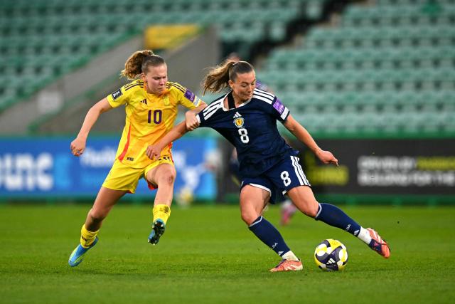 Belgium's midfielder #10 Jarne Teulings battles for the ball with Scotland's Midfielder #08 Miri Taylor during the Women's FIFA world cup league B, group 4, qualifier football match between Scotland and Belgium at Easter Road, in Edinburgh, Scotland, on April 14, 2026. (Photo by ANDY BUCHANAN / AFP)