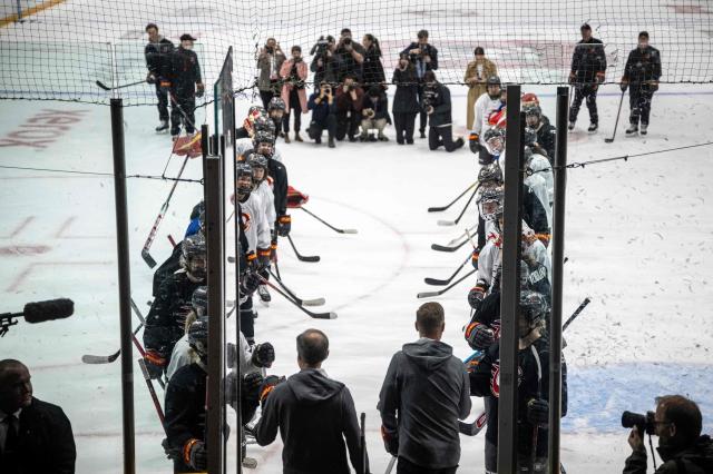 Canadian Prime Minister Mark Carney (L) and Finland's President Alexander Stubb greet members of the Ottawa Charge women's professional hockey team at TD Place Arena in Ottawa, Canada on April 14, 2026. (Photo by ANDREJ IVANOV / AFP)