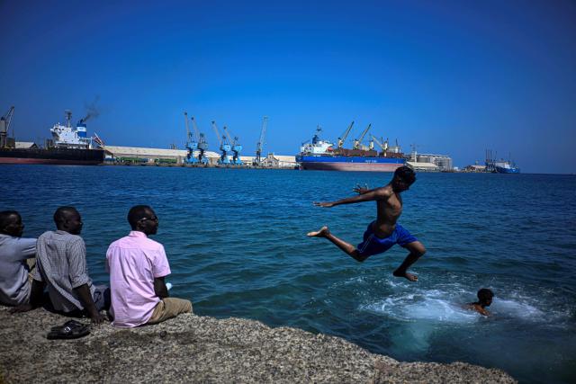 Sudanese youths dive into the red sea in Port Sudan on April 14, 2026. (Photo by Khaled DESOUKI / AFP)