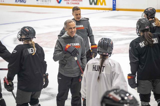 Canadian Prime Minister Mark Carney and Finland's President Alexander Stubb speak with members of the Ottawa Charge women's professional hockey team at TD Place Arena in Ottawa, Canada on April 14, 2026. (Photo by ANDREJ IVANOV / AFP)