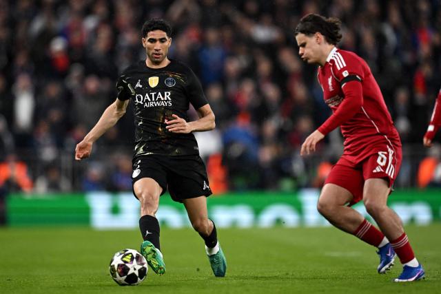 Paris Saint-Germain's Moroccan defender #02 Achraf Hakimi is put under pressure by Liverpool's Hungarian defender #06 Milos Kerkez during the UEFA Champions League quarter final, second-leg football match between Liverpool and Paris Saint-Germain at Anfield in Liverpool, north west England on April 14, 2026. (Photo by Paul ELLIS / AFP)