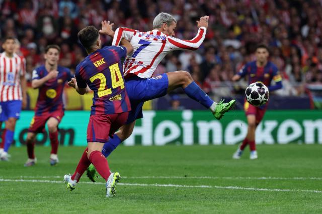 Atletico Madrid's French forward #07 Antoine Griezmann fights for the ball with Barcelona's Spanish defender #24 Eric Garcia during the UEFA Champions League quarter final second leg football match between Club Atletico de Madrid and FC Barcelona at Metropolitano Stadium in Madrid on April 14, 2026. (Photo by Thomas COEX / AFP)