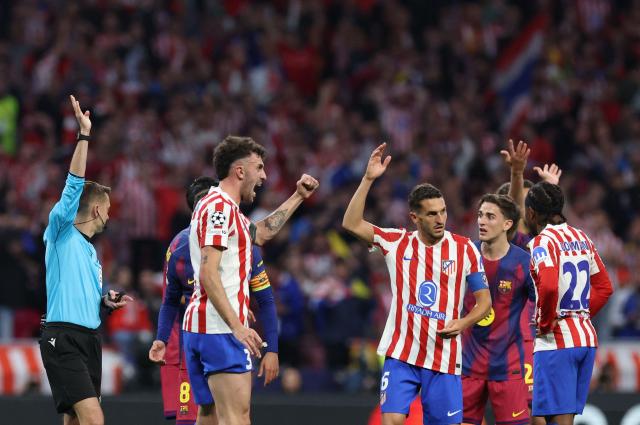 Atletico Madrid's Italian defender #03 Matteo Ruggeri and Atletico Madrid's Spanish midfielder #06 Koke celebrate as French referee Clement Turpin rules offsides on a Barcelona goal during the UEFA Champions League quarter final second leg football match between Club Atletico de Madrid and FC Barcelona at Metropolitano Stadium in Madrid on April 14, 2026. (Photo by Oscar DEL POZO / AFP)