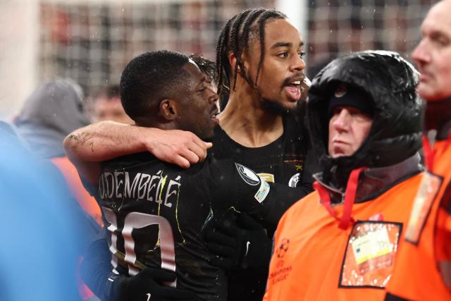 Paris Saint-Germain's French forward #10 Ousmane Dembele (L) celebrates scoring the team's second goal during the UEFA Champions League quarter final, second-leg football match between Liverpool and Paris Saint-Germain at Anfield in Liverpool, north west England on April 14, 2026. (Photo by FRANCK FIFE / AFP)