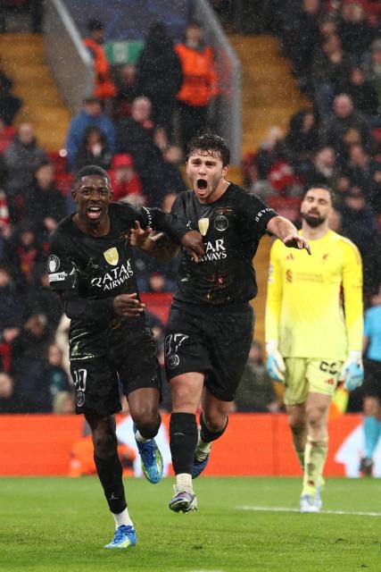 Paris Saint-Germain's French forward #10 Ousmane Dembele (L) celebrates scoring the team's second goal with Paris Saint-Germain's Portuguese midfielder #87 Joao Neves during the UEFA Champions League quarter final, second-leg football match between Liverpool and Paris Saint-Germain at Anfield in Liverpool, north west England on April 14, 2026. (Photo by FRANCK FIFE / AFP)