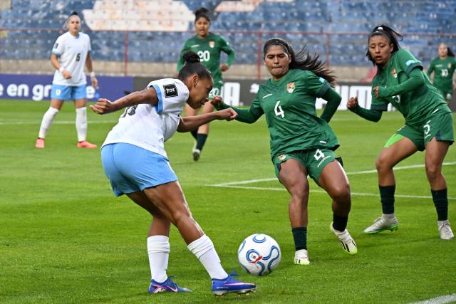 Uruguay's forward #19 Wendy Carballo, Bolivia's defender #04 Aide Mendiola and Bolivia's midfielder #05 Ruth Soliz fight for the ball during the CONMEBOL Nations League Women football match between Bolivia and Uruguay at the Municipal de El Alto stadium in El Alto, La Paz department, Bolivia, on April 14, 2026. (Photo by AIZAR RALDES / AFP)