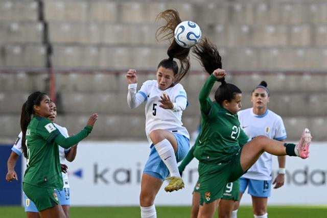 Uruguay's midfielder #05 Karol Bermudez and Bolivia's midfielder #21 Abigail Quiroz fight for the ball during the CONMEBOL Nations League Women football match between Bolivia and Uruguay at the Municipal de El Alto stadium in El Alto, La Paz department, Bolivia, on April 14, 2026. (Photo by AIZAR RALDES / AFP)