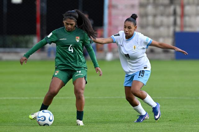 Bolivia's defender #04 Aide Mendiola and Uruguay's forward #19 Wendy Carballo fight for the ball during the CONMEBOL Nations League Women football match between Bolivia and Uruguay at the Municipal de El Alto stadium in El Alto, La Paz department, Bolivia, on April 14, 2026. (Photo by AIZAR RALDES / AFP)