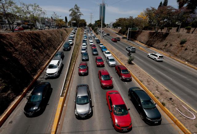 Uber and Didi app drivers take part in a protest against the fares charged by the app companies per trip and federal government operations in Zapopan, Mexico, on April 14, 2026. (Photo by ULISES RUIZ / AFP)