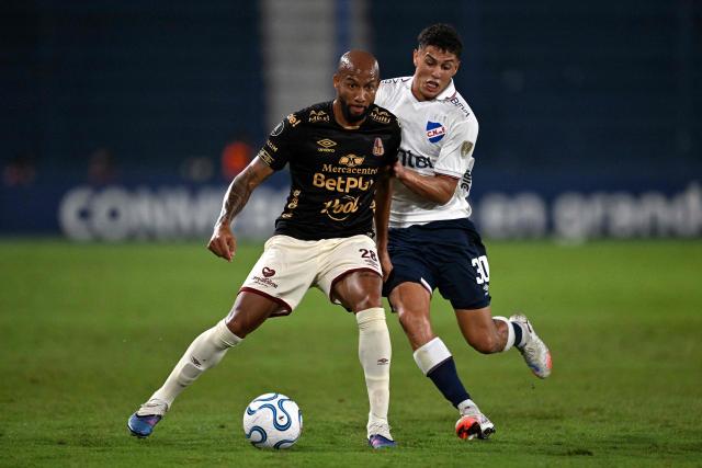 Tolima's forward #28 Edwar Lopez and Nacional's midfielder #30 Baltasar Barcia fight for the ball during the Copa Libertadores group stage football match between Uruguay's Nacional and Colombia's Deportes Tolima at the Gran Parque Central stadium in Montevideo on April 14, 2026. (Photo by Eitan ABRAMOVICH / AFP)