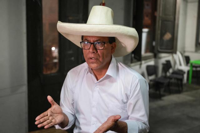 Peru's presidential candidate for the Juntos por el Peru party, Roberto Sanchez, gestures as he speaks during an interview with AFP at his campaign office in Lima on April 14, 2026. Ultra-conservative candidate Rafael Lopez Aliaga, who is vying for a spot in the runoff of Peru’s presidential election, called on election authorities on April 14 to declare the election “null and void” due to unproven irregularities in the process. (Photo by Connie FRANCE / AFP)