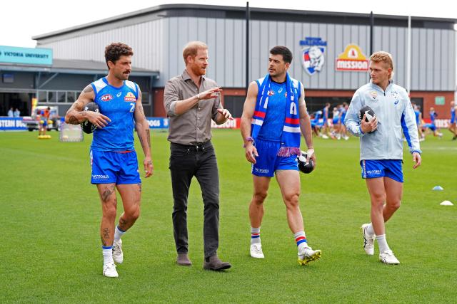 Britain's Prince Harry, Duke of Sussex (2/L), meets with Western Bulldogs Australian Football League (AFL) players during a visit to a Movember event at Whitten Oval in Melbourne on April 15, 2026. (Photo by Jonathan Brady / POOL / AFP)