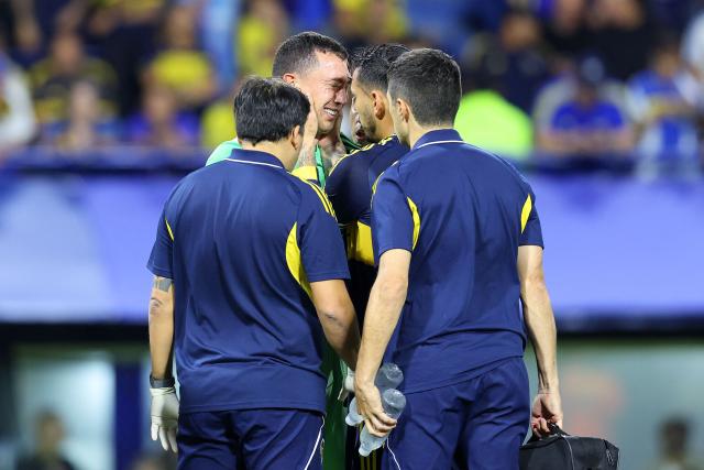Boca Juniors' goalkeeper #01 Agustin Marchesin cries after being injured during the Copa Libertadores group stage football match between Argentina's Boca Juniors and Ecuador's Barcelona at La Bombonera stadium in Buenos Aires on April 14, 2026. (Photo by ALEJANDRO PAGNI / AFP)