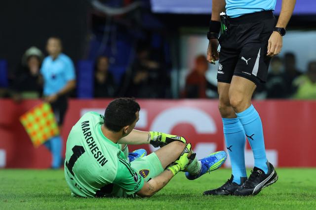 Boca Juniors' goalkeeper #01 Agustin Marchesin touches his injured knee during the Copa Libertadores group stage football match between Argentina's Boca Juniors and Ecuador's Barcelona at La Bombonera stadium in Buenos Aires on April 14, 2026. (Photo by ALEJANDRO PAGNI / AFP)