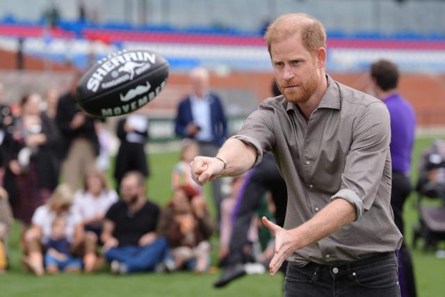 Britain's Prince Harry, Duke of Sussex, does a hand pass during a Western Bulldogs Australian rules football session during a visit to a Movember event at Whitten Oval in Melbourne on April 15, 2026. (Photo by Jonathan Brady / POOL / AFP)