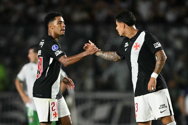 Vasco da Gama's forward #20 Brenner celebrates with Vasco da Gama's defender #43 Lucas Freitas after scoring his team's first goal during the Copa Sudamericana group stage football match between Brazil's Vasco da Gama and Chile's Audax Italiano at the Sao Januario stadium in Rio de Janeiro, Brazil, on April 14, 2026. (Photo by MAURO PIMENTEL / AFP)