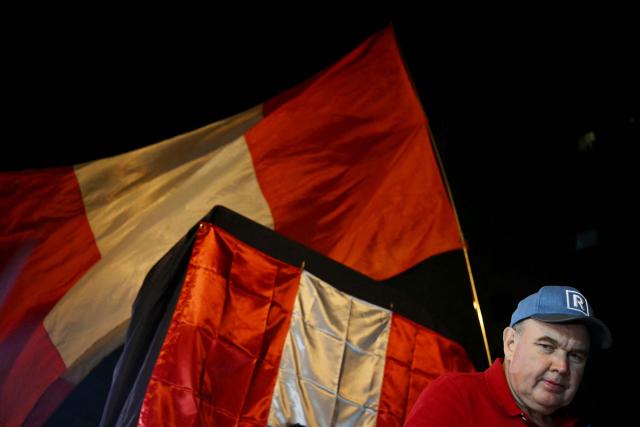 Peru's presidential candidate for the Renovacion Popular party, Rafael Lopez Aliaga, looks on during a protest over alleged fraud following the results of the presidential election in front of the National Jury of Elections (JNE) headquarters in Lima on April 14, 2026. Ultra-conservative candidate Rafael Lopez Aliaga, who is vying for a spot in the runoff of Peru’s presidential election, called on election authorities on April 14 to declare the election “null and void” due to unproven irregularities in the process. (Photo by ERNESTO BENAVIDES / AFP)