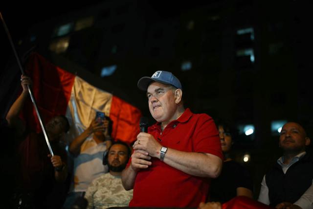 Peru's presidential candidate for the Renovacion Popular party, Rafael Lopez Aliaga, gestures during a protest over alleged fraud following the results of the presidential election in front of the National Jury of Elections (JNE) headquarters in Lima on April 14, 2026. Ultra-conservative candidate Rafael Lopez Aliaga, who is vying for a spot in the runoff of Peru’s presidential election, called on election authorities on April 14 to declare the election “null and void” due to unproven irregularities in the process. (Photo by ERNESTO BENAVIDES / AFP)