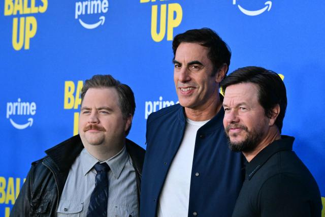 (L-R) US actor Paul Walter Hauser, English actor Sacha Baron Cohen and US actor Mark Wahlberg attend the premiere of Amazon MGM's "Balls Up" at Harmony Gold in Los Angeles on April 14, 2026. (Photo by Frederic J. Brown / AFP)