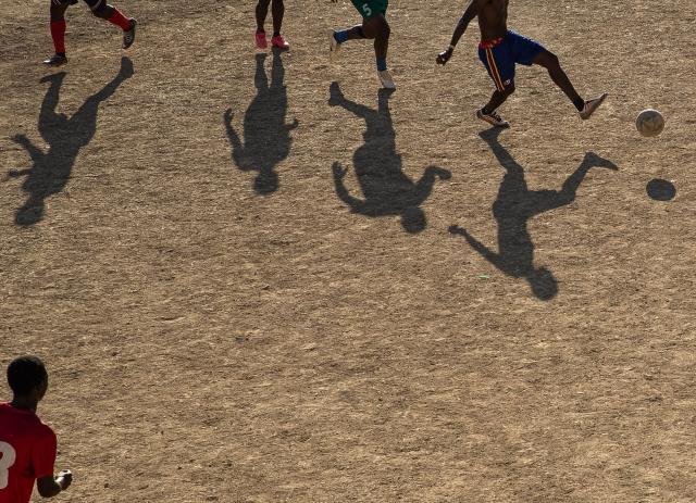 People play football in Petion-ville, Port-au-Prince, Haiti, on April 12, 2026. The Haitian national team has qualified for the 2026 FIFA World Cup, just the second time in its history. Football is the most popular sport in Haiti. (Photo by Clarens SIFFROY / AFP)