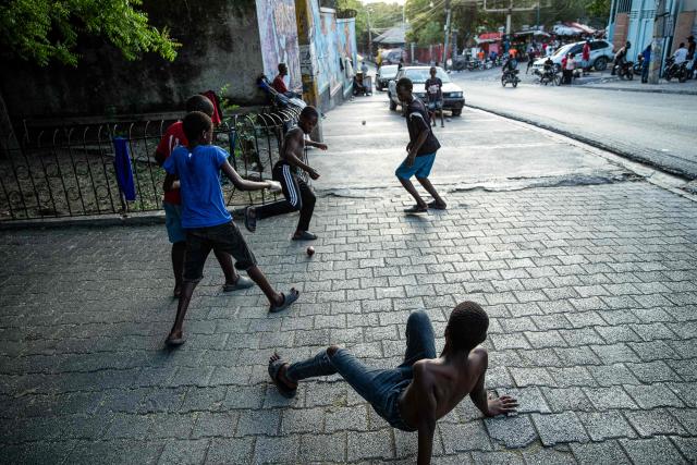 Children play football in the city center, Port-au-Prince, Haiti, on April 11, 2026. The Haitian national team has qualified for the 2026 FIFA World Cup, just the second time in its history. Football is the most popular sport in Haiti. (Photo by Clarens SIFFROY / AFP)