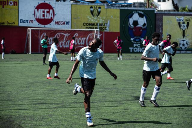 A player celebrates his goal during a football match in Petion-ville, Port-au-Prince, Haiti, on April 11, 2026. The Haitian national team has qualified for the 2026 FIFA World Cup, just the second time in its history. Football is the most popular sport in Haiti. (Photo by Clarens SIFFROY / AFP)