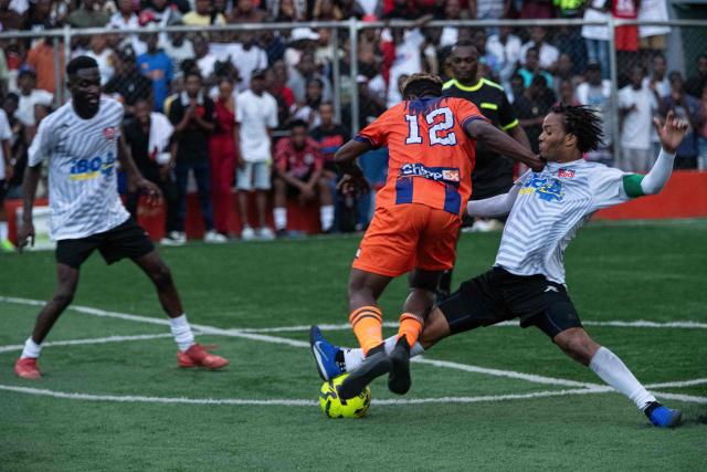 People play football in Petion-ville, Port-au-Prince, Haiti, on April 12, 2026. The Haitian national team has qualified for the 2026 FIFA World Cup, just the second time in its history. Football is the most popular sport in Haiti. (Photo by Clarens SIFFROY / AFP)