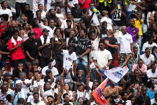 People react after a goal during a football match in Petion-ville, Port-au-Prince, Haiti, on April 12, 2026. The Haitian national team has qualified for the 2026 FIFA World Cup, just the second time in its history. Football is the most popular sport in Haiti. (Photo by Clarens SIFFROY / AFP)