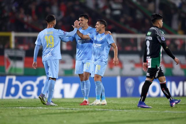 Montevideo City Torque players Argentine midfielder #19 Diogo Guzman, defender #17 Eduardo Aguero and defender #26 Facundo Silvera celebrate after winning the Copa Sudamericana group stage football match between Chile's Palestino and Uruguay's Montevideo City Torque at Municipal de la Cisterna stadium in Santiago on April 14, 2026. (Photo by Javier TORRES / AFP)