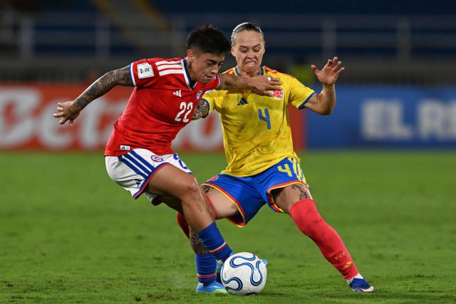 Chile's defender #22 Valentina Diaz and Colombia's defender #04 Ana Guzman fight for the ball during the CONMEBOL Nations League Women football match between Colombia and Chile, at the Olimpico Pascual Guerrero stadium in Cali, Valle del Cauca, Colombia, on April 14, 2026. (Photo by JOAQUIN SARMIENTO / AFP)